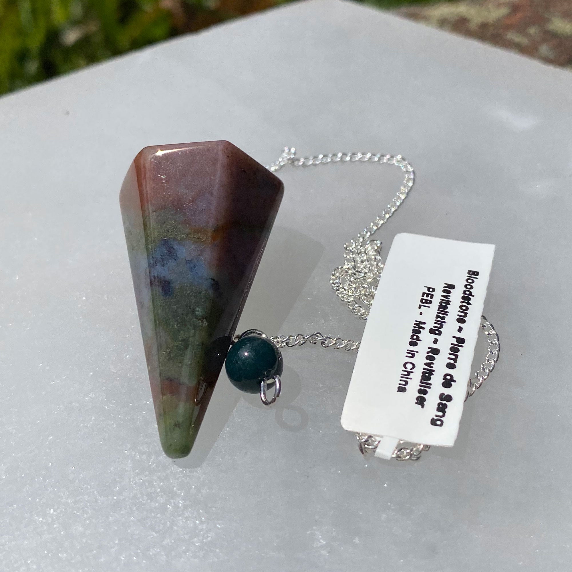 Bloodstone Pendulum #1 on a chain, showcasing its unique gemstone properties and elegant design.