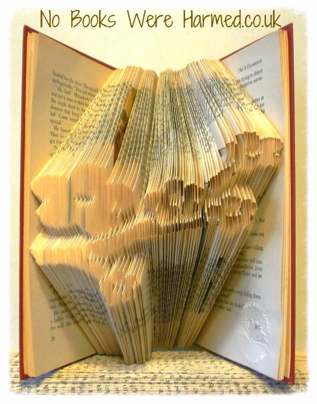 A beautifully crafted hand-folded book art piece made from vintage books, showcasing intricate designs and unique colors.