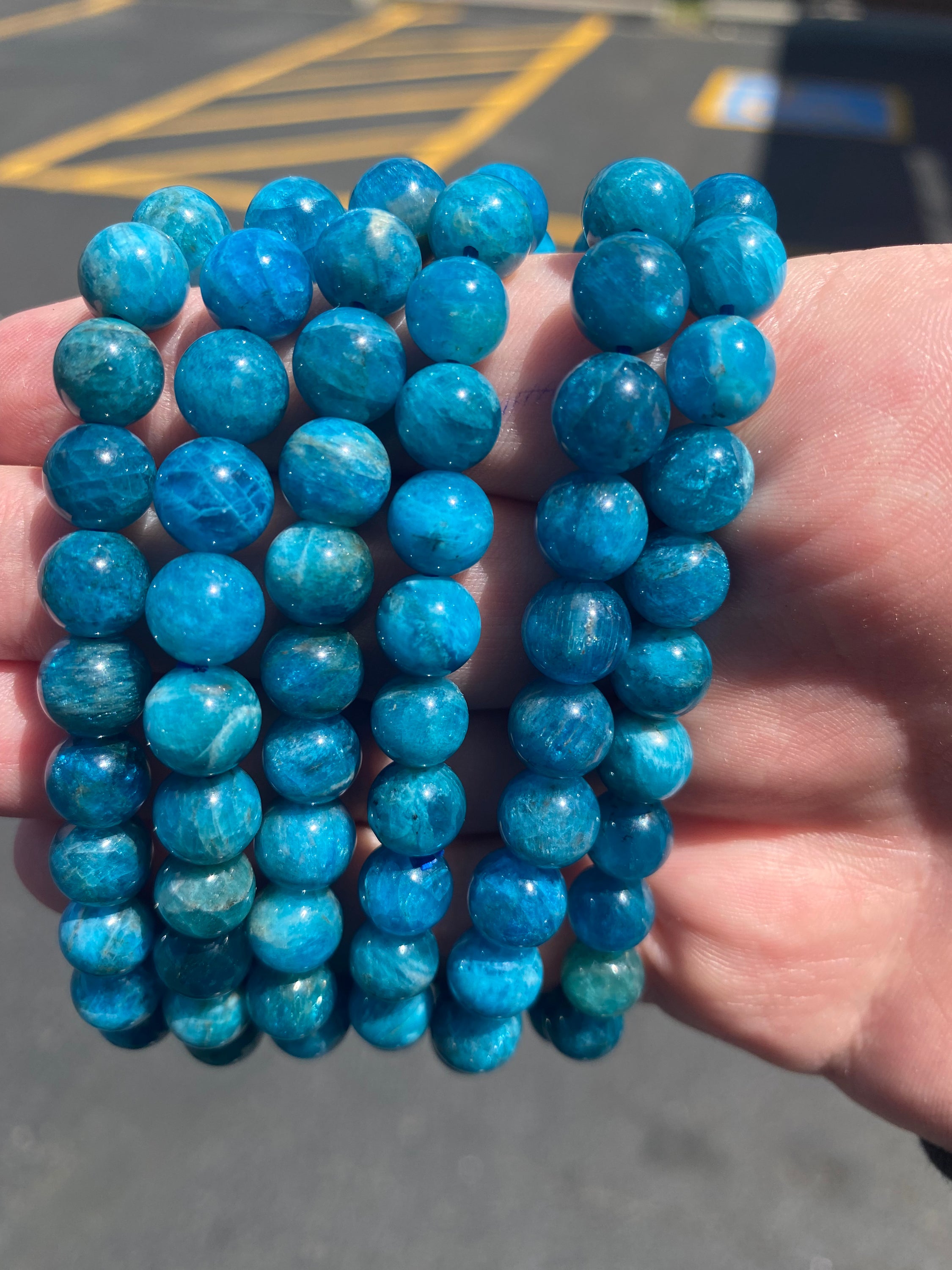 A beautiful Blue Apatite Bracelet featuring 8mm smooth beads in deep blue tones, perfect for spiritual healing and meditation.