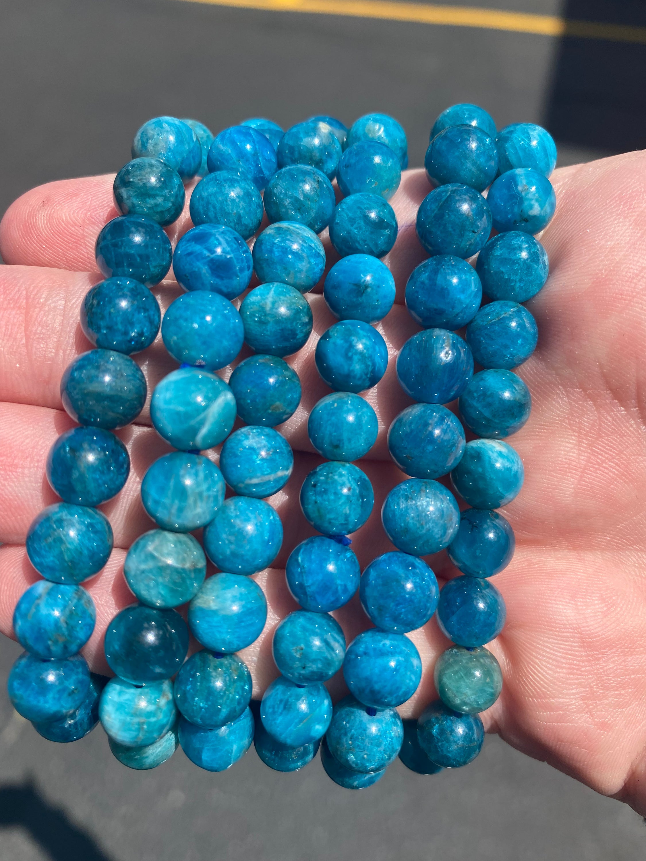 A beautiful Blue Apatite Bracelet featuring 8mm smooth beads in deep blue tones, perfect for spiritual healing and meditation.