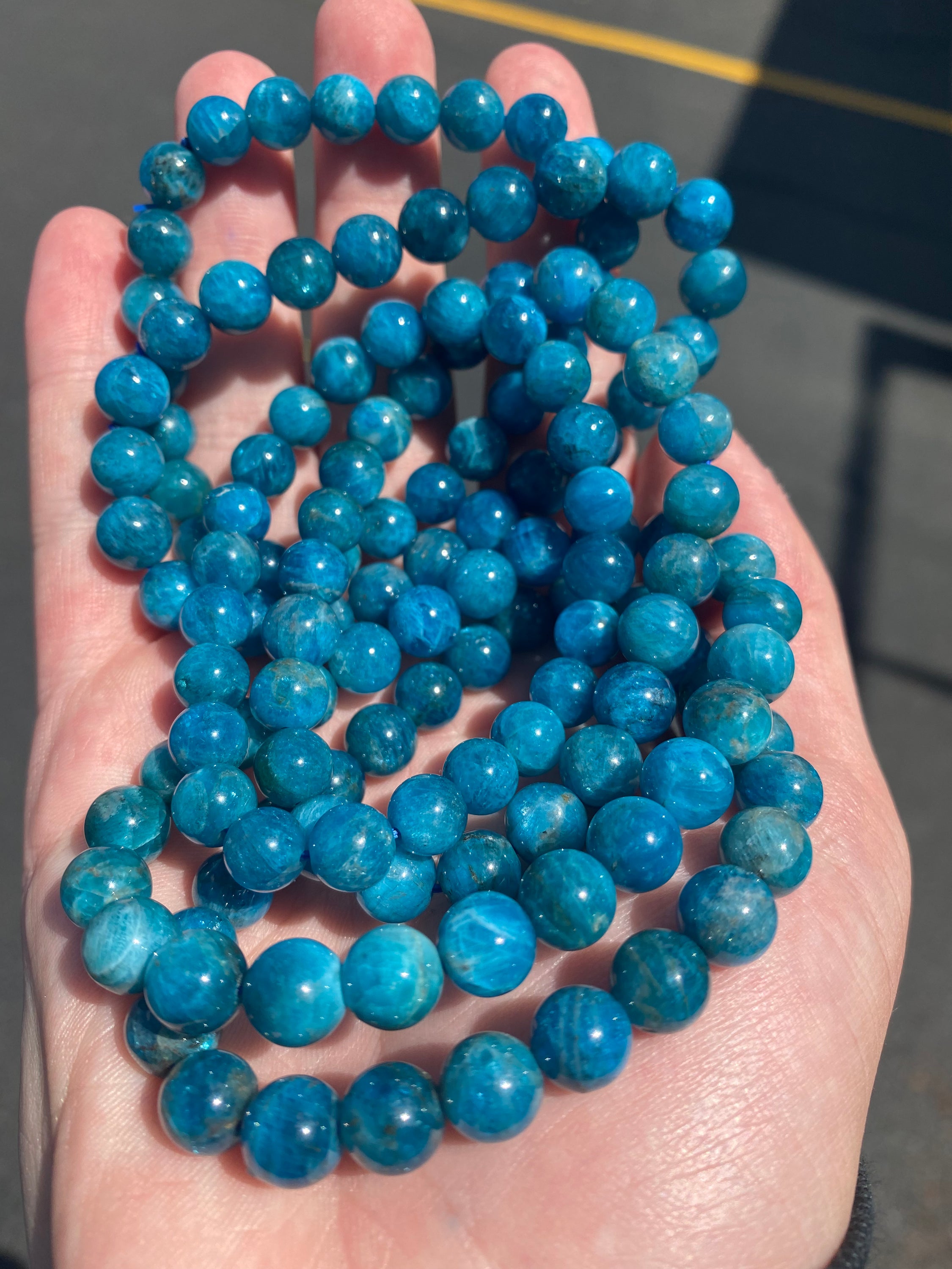 A beautiful Blue Apatite Bracelet featuring 8mm smooth beads in deep blue tones, perfect for spiritual healing and meditation.