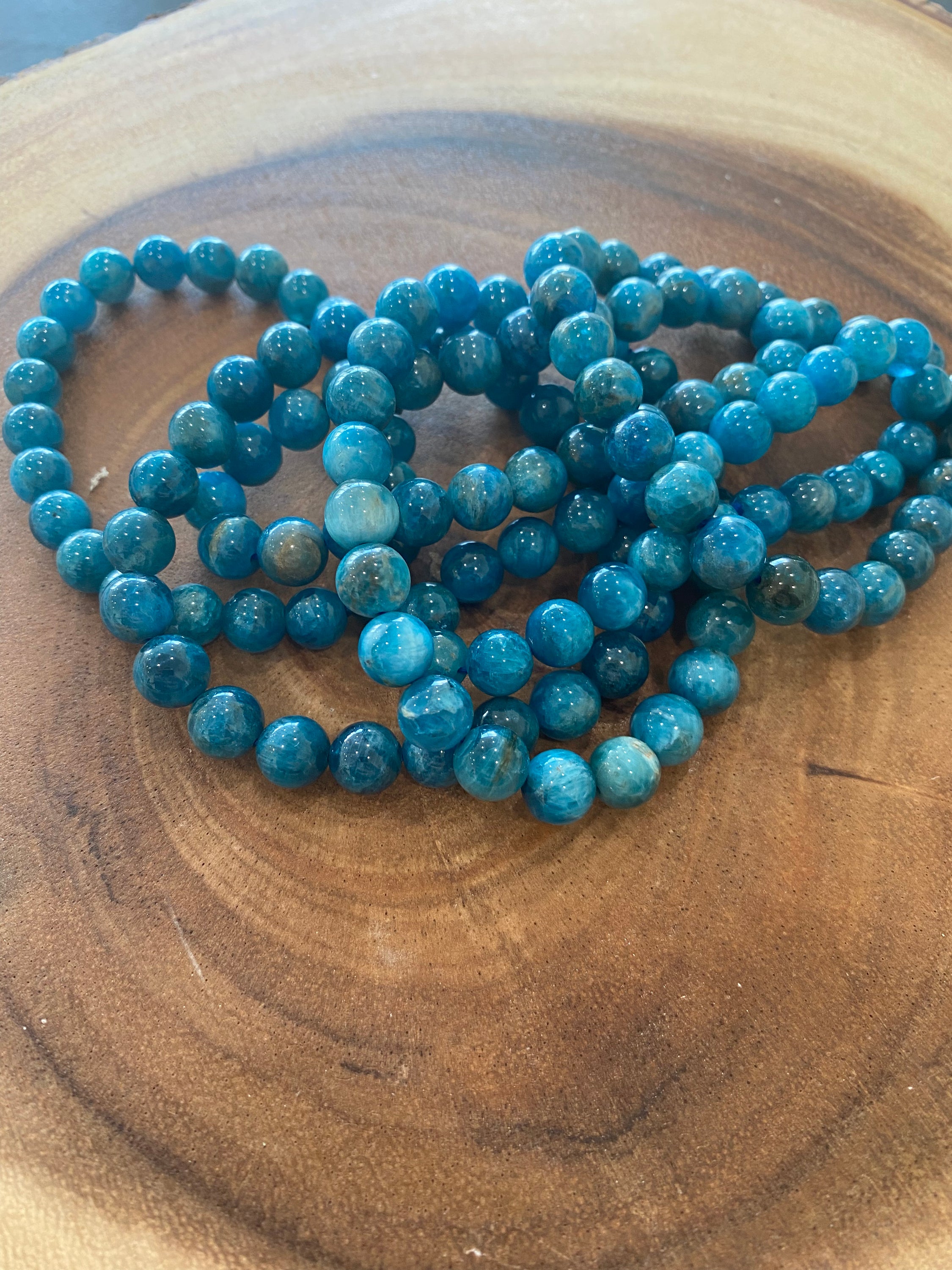 A beautiful Blue Apatite Bracelet featuring 8mm smooth beads in deep blue tones, perfect for spiritual healing and meditation.