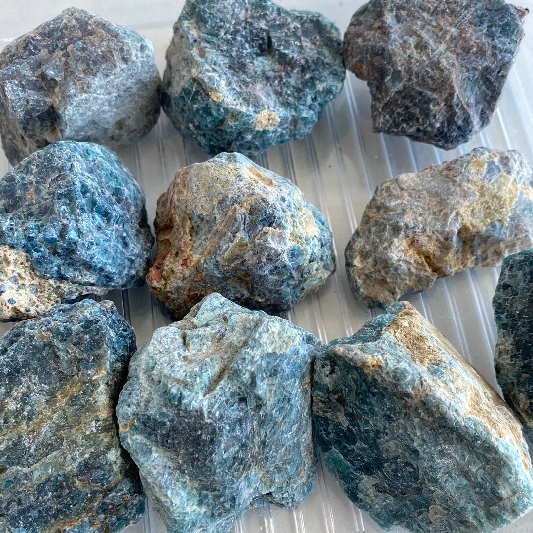 A polished Blue Apatite Rough Cut stone showcasing its deep aqua color and smooth texture, perfect for healing and decoration.