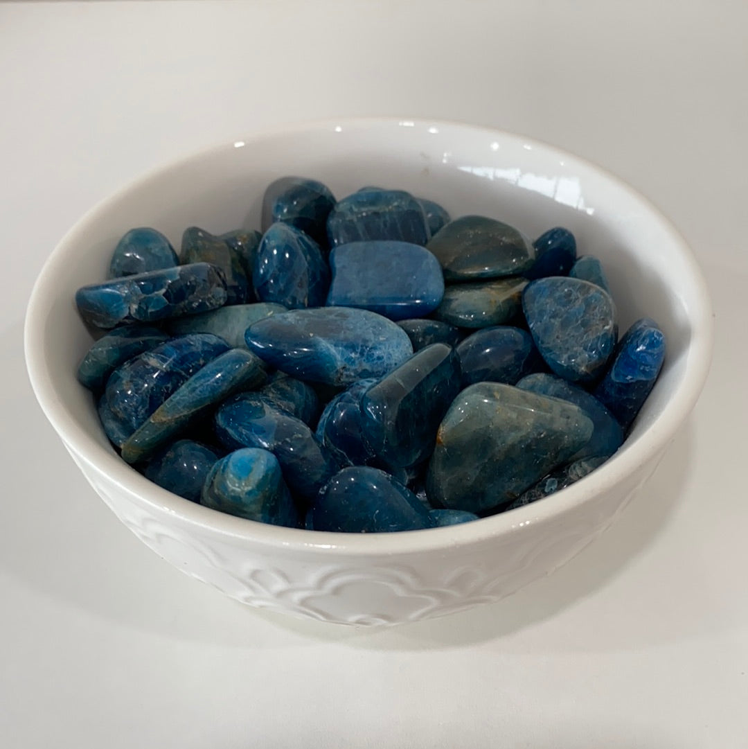 A polished Blue Apatite Tumbled Stone showcasing its deep aqua color and smooth surface, perfect for healing and meditation.