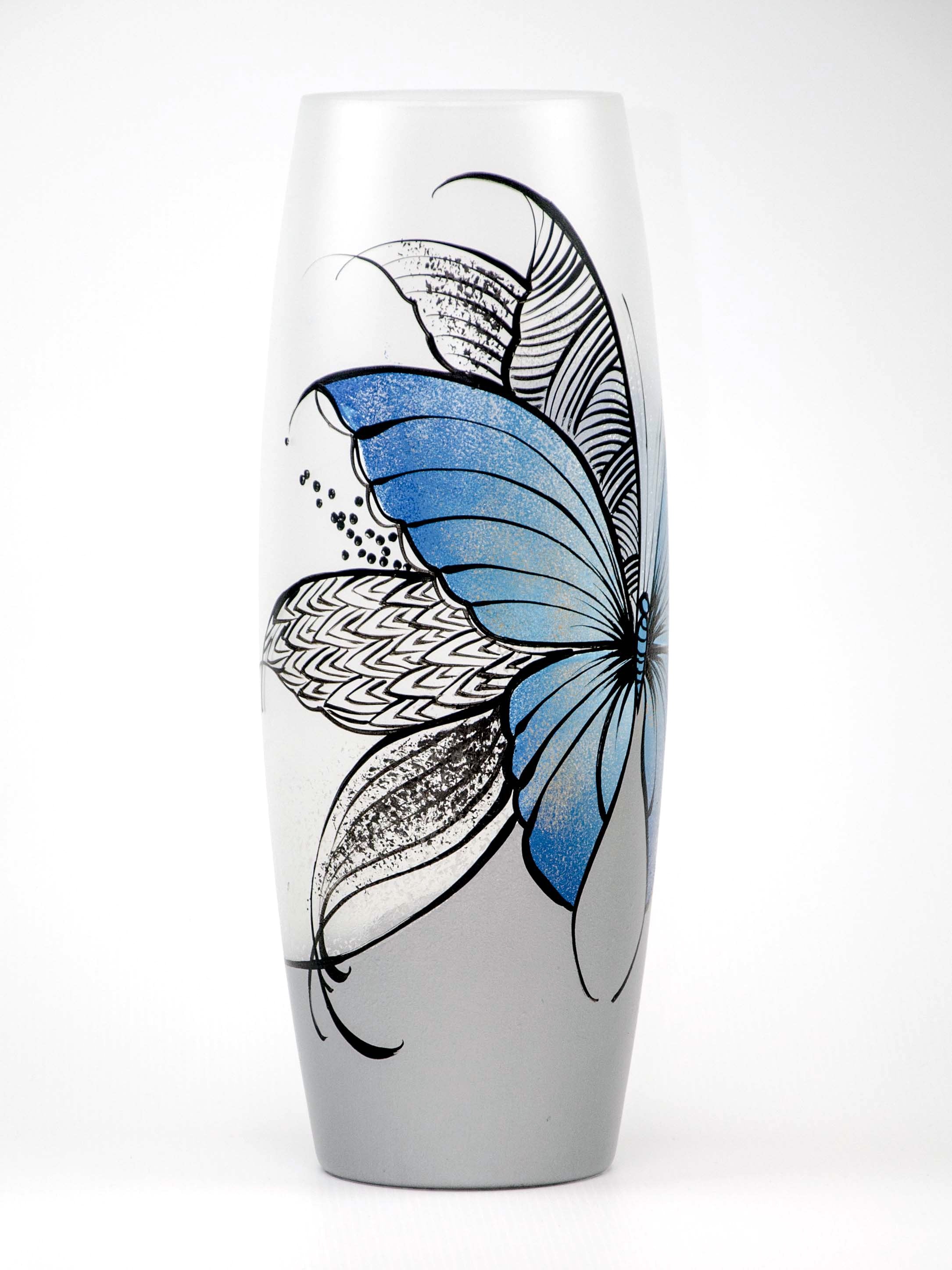 Large handpainted glass vase featuring a blue butterfly design, perfect for displaying flowers.