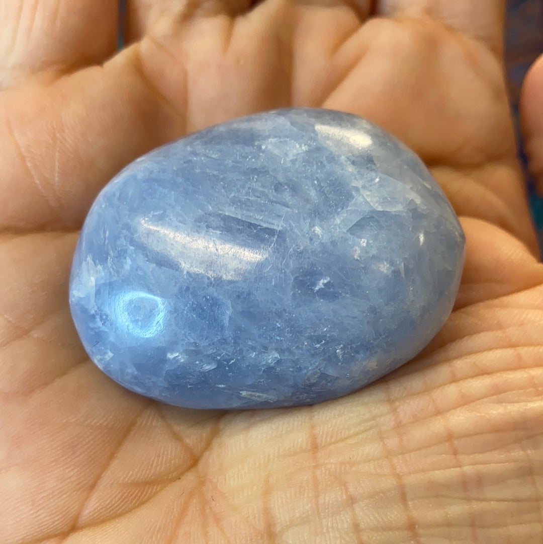 A collection of Blue Calcite Polished Nuggets showcasing various shapes and sizes, radiating calming blue hues.