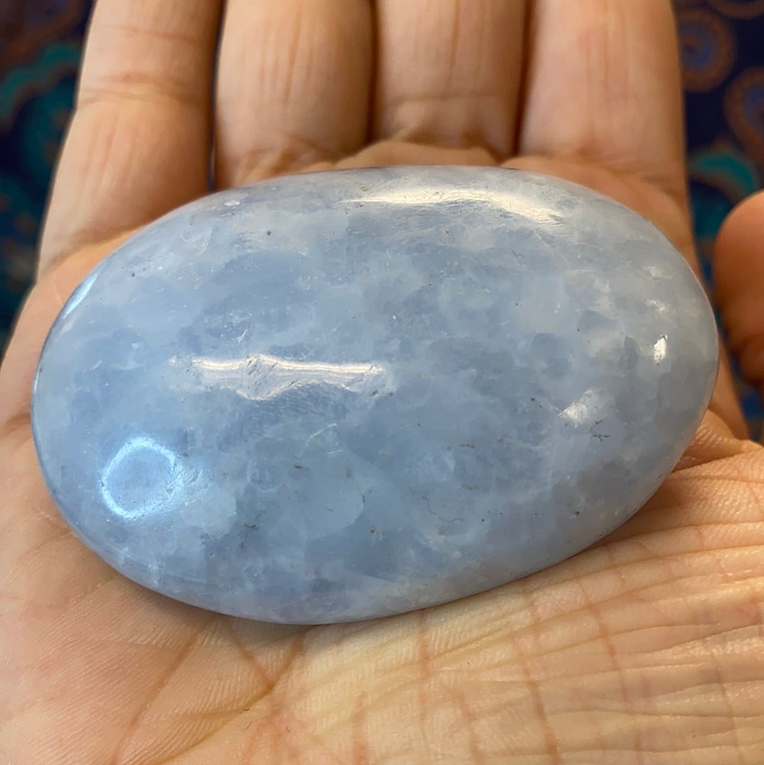 A collection of Blue Calcite Polished Nuggets showcasing various shapes and sizes, radiating calming blue hues.