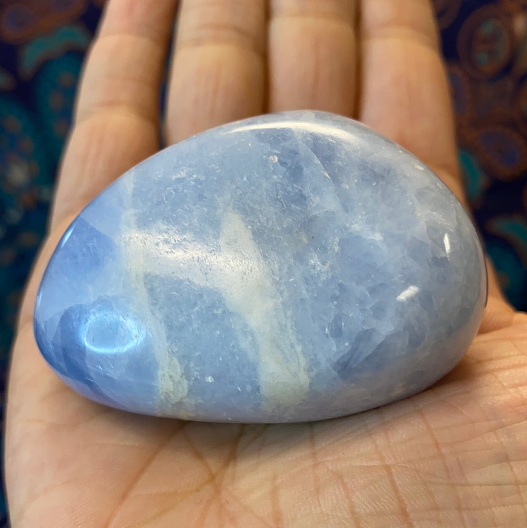 A collection of Blue Calcite Polished Nuggets showcasing various shapes and sizes, radiating calming blue hues.