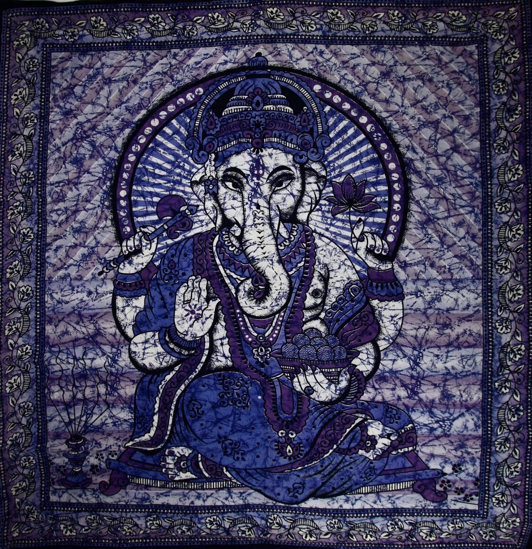 A vibrant blue tapestry featuring Ganesha holding a lotus flower in a batik style tie-dye design, perfect for home decor.