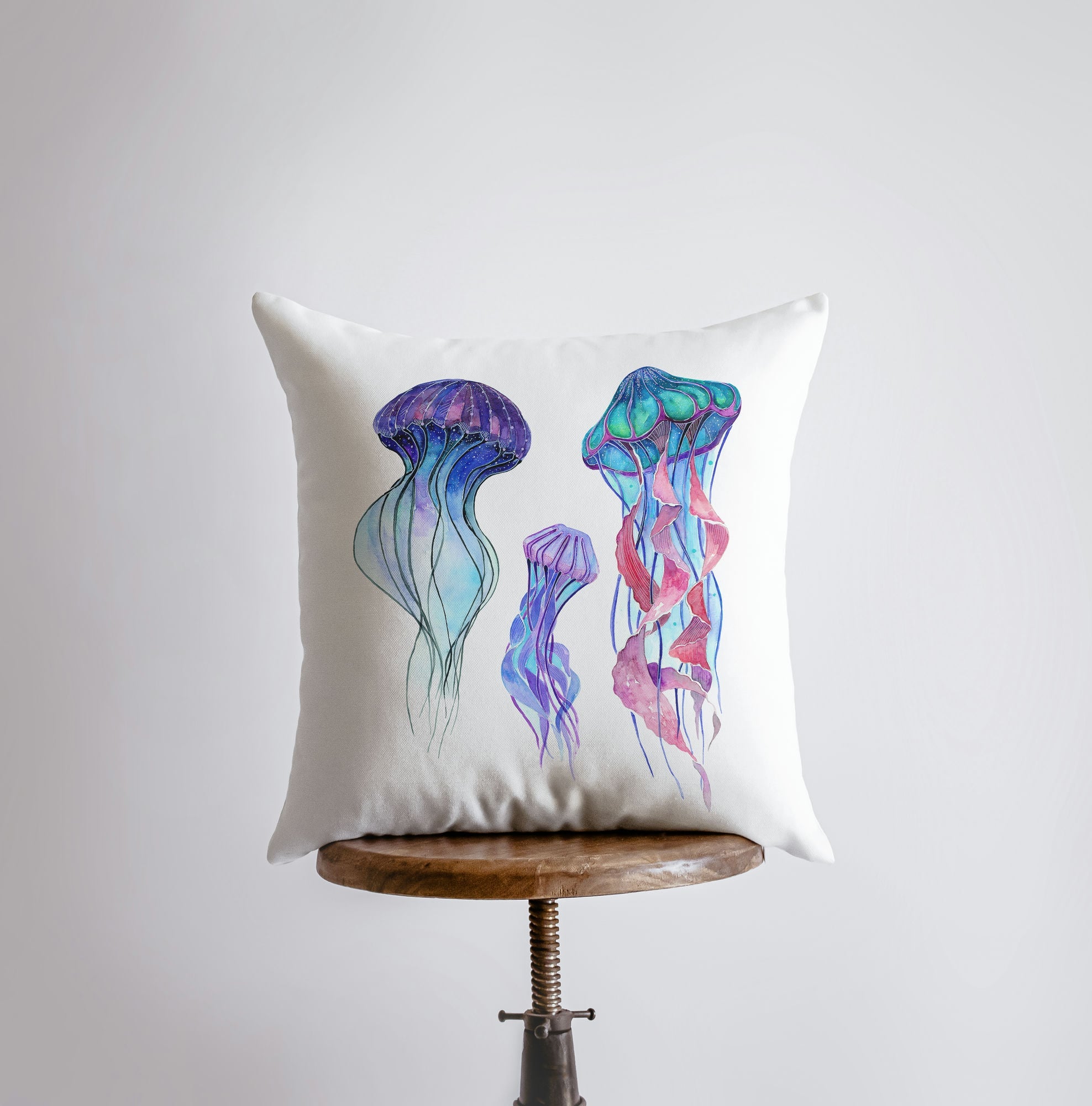 A beautifully designed Blue Jelly Fish pillow cover featuring a vibrant jellyfish on one side and a repeating pattern on the other, perfect for coastal decor.