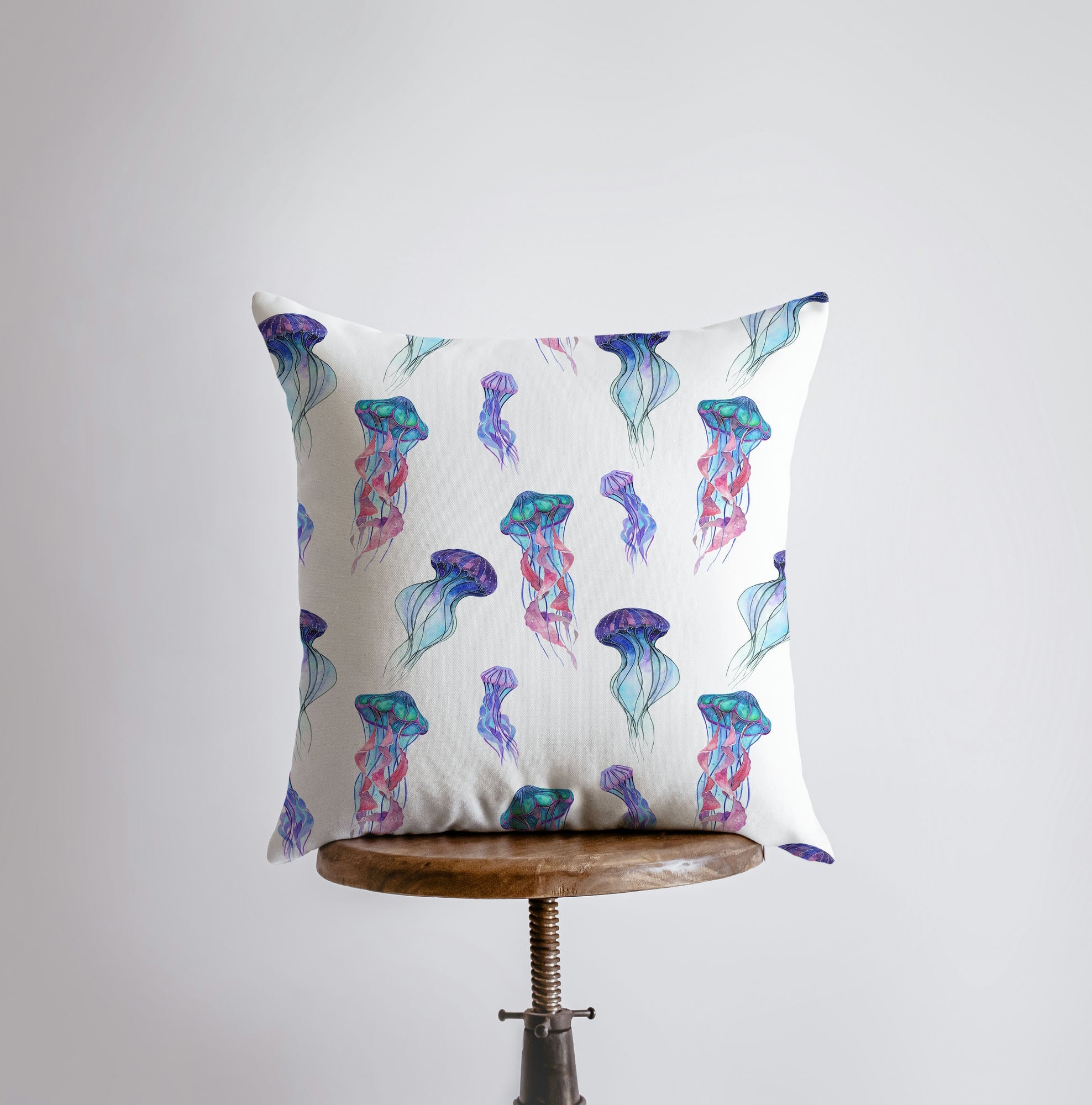 A beautifully designed Blue Jelly Fish pillow cover featuring a vibrant jellyfish on one side and a repeating pattern on the other, perfect for coastal decor.