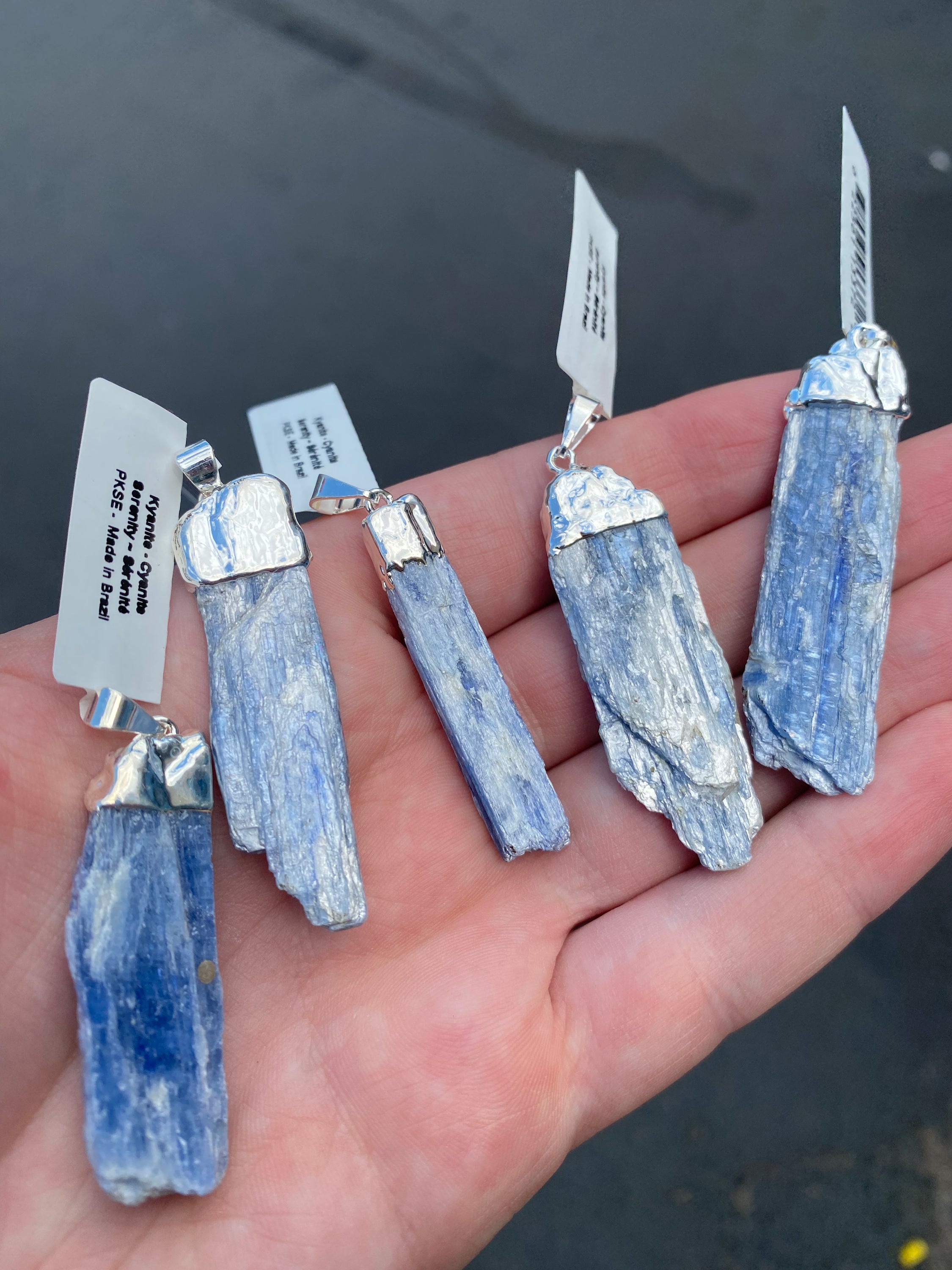 A beautiful Blue Kyanite Pendant with a sterling silver chain, showcasing its unique blade-like structure and deep blue color.