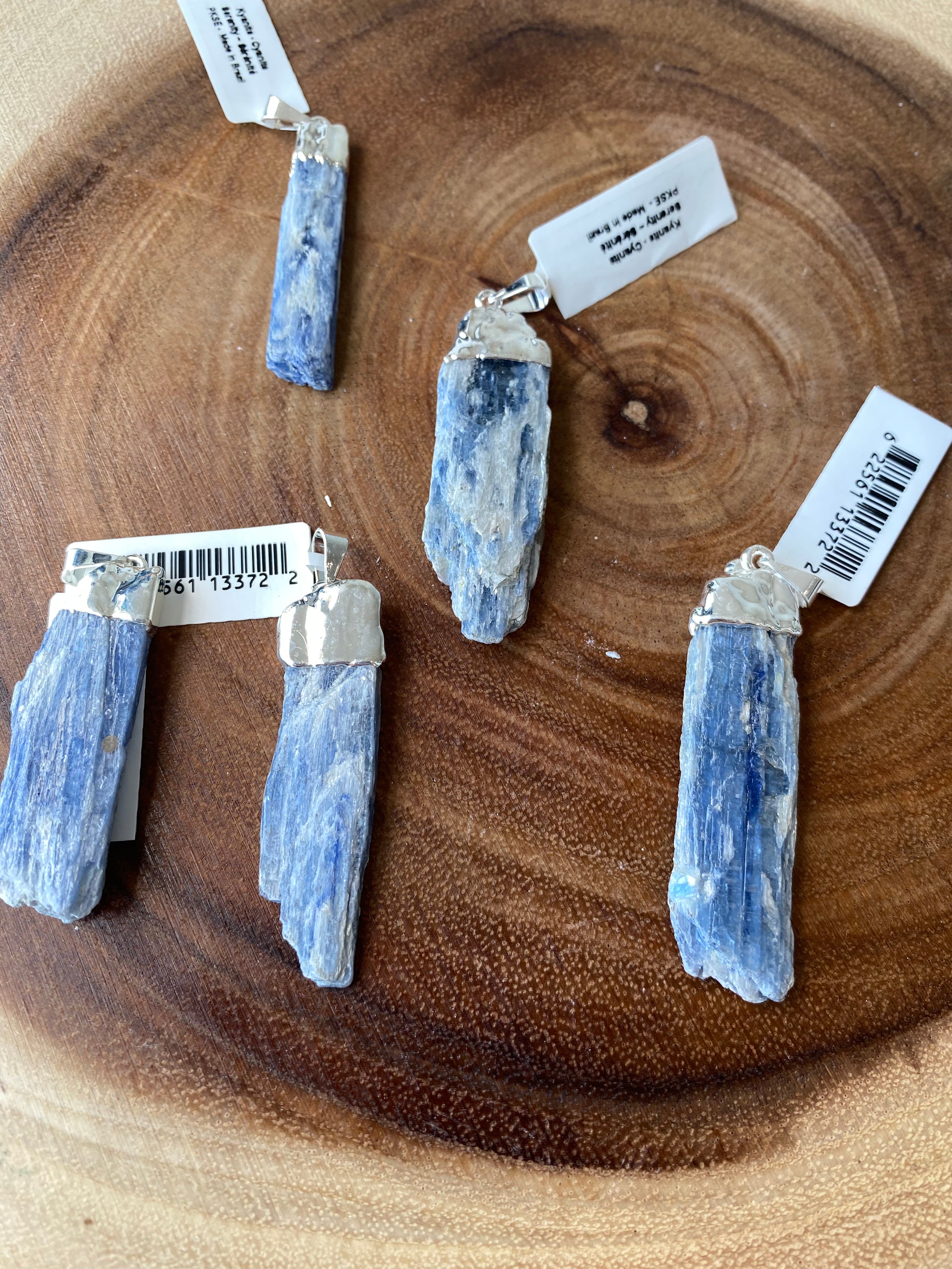 A beautiful Blue Kyanite Pendant with a sterling silver chain, showcasing its unique blade-like structure and deep blue color.