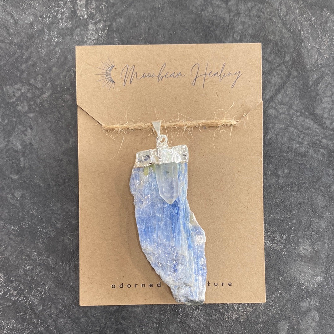 A rough cut Blue Kyanite crystal with Clear Quartz, elegantly silver electro-plated, showcasing its natural beauty and energy.