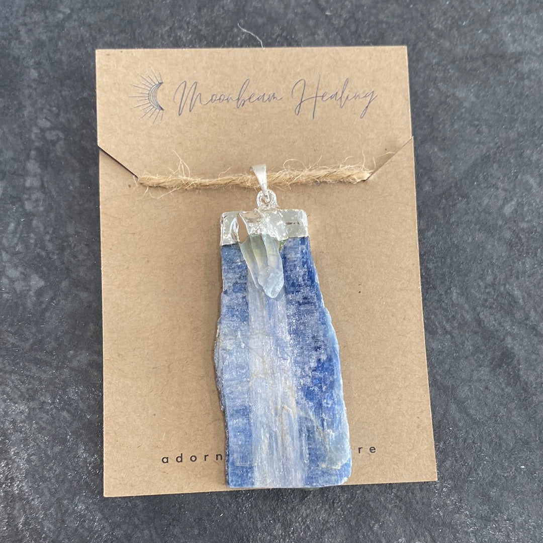 A rough cut Blue Kyanite crystal with Clear Quartz, elegantly silver electro-plated, showcasing its natural beauty and energy.