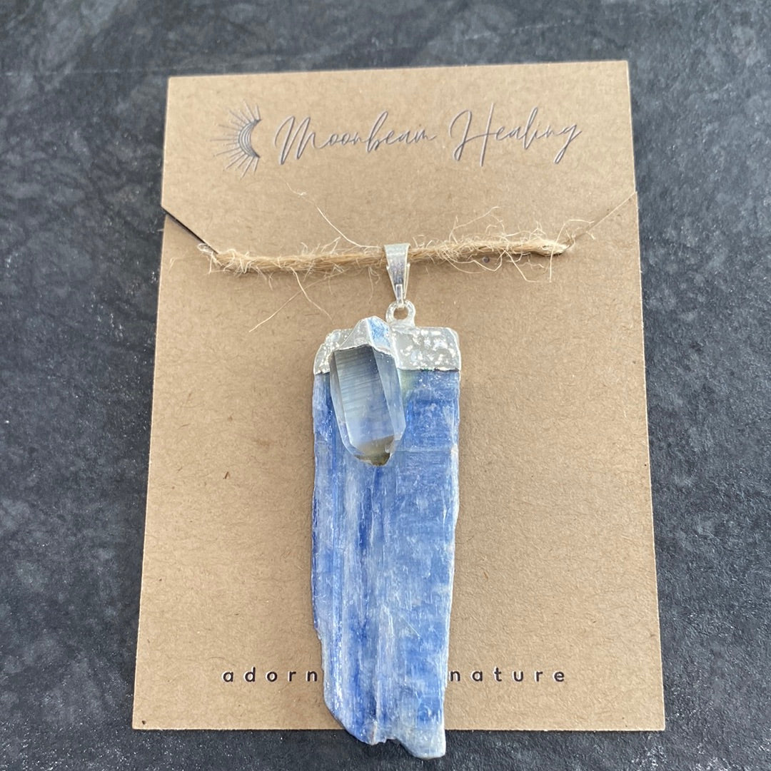 A rough cut Blue Kyanite crystal with Clear Quartz, elegantly silver electro-plated, showcasing its natural beauty and energy.