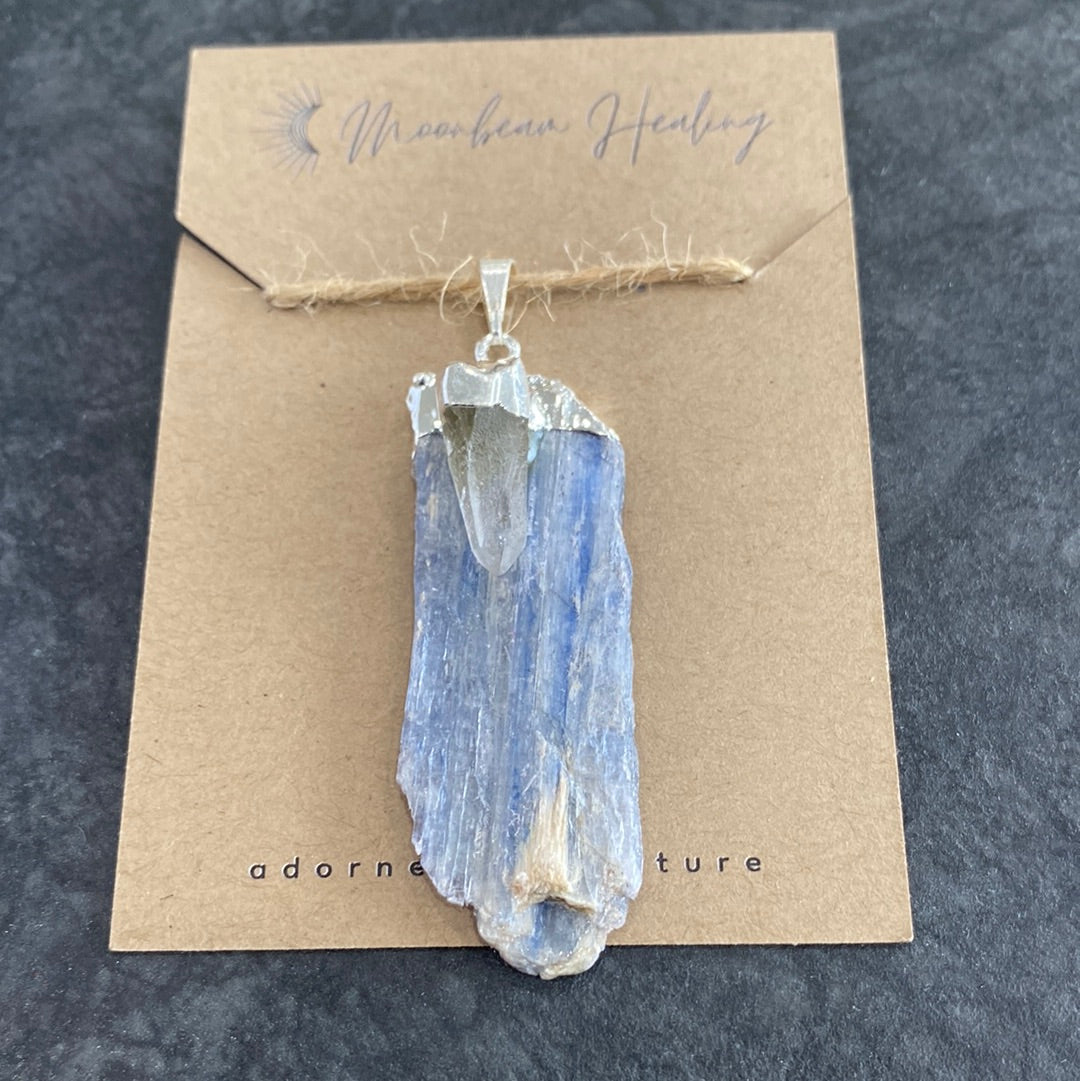 A rough cut Blue Kyanite crystal with Clear Quartz, elegantly silver electro-plated, showcasing its natural beauty and energy.