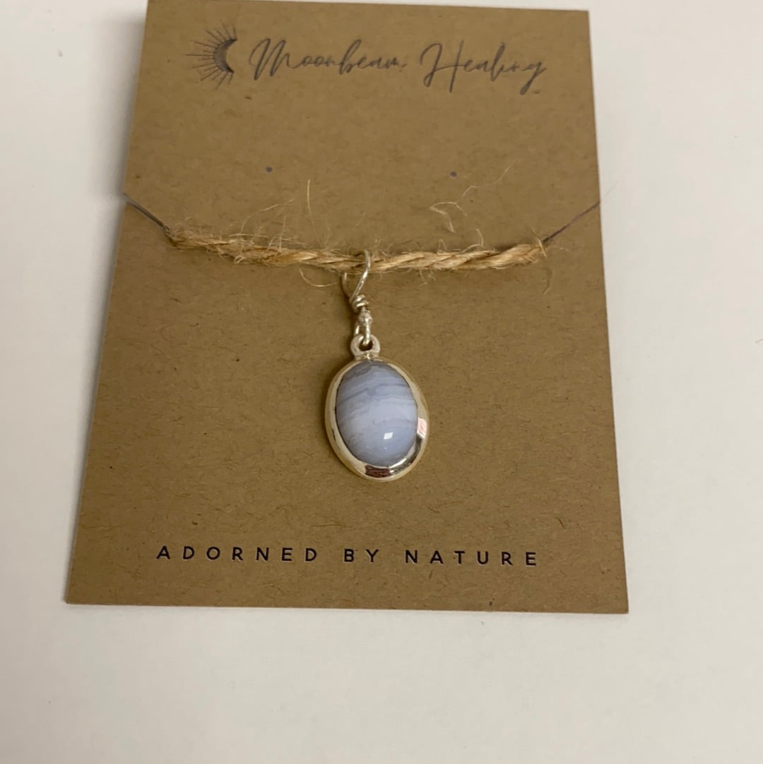 A handcrafted Blue Lace Agate Sterling Silver Pendant showcasing unique blue and white patterns, elegantly set in sterling silver.