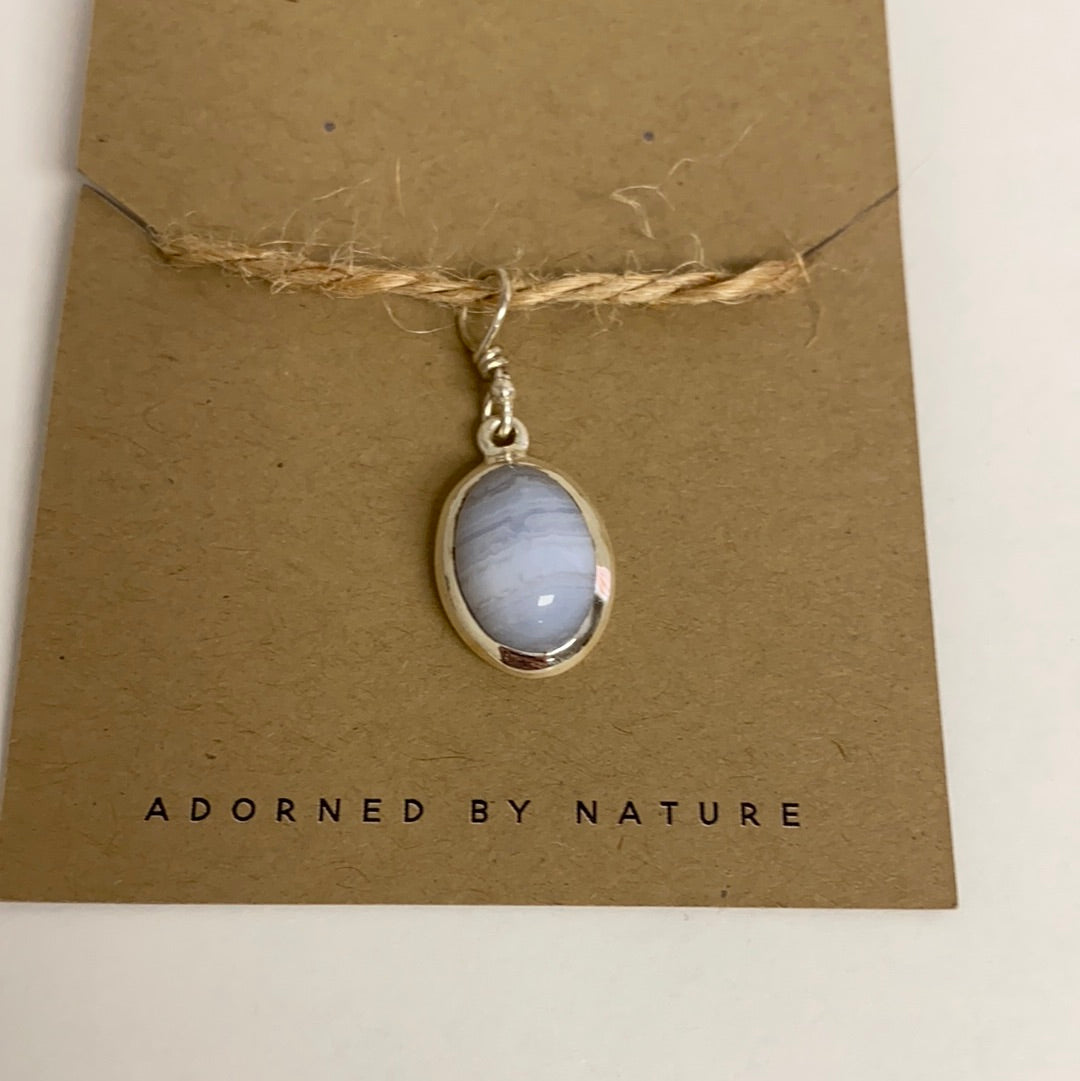 A handcrafted Blue Lace Agate Sterling Silver Pendant showcasing unique blue and white patterns, elegantly set in sterling silver.