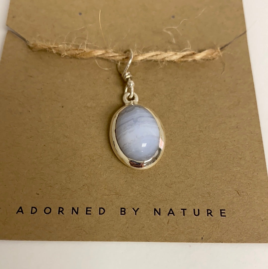 A handcrafted Blue Lace Agate Sterling Silver Pendant showcasing unique blue and white patterns, elegantly set in sterling silver.