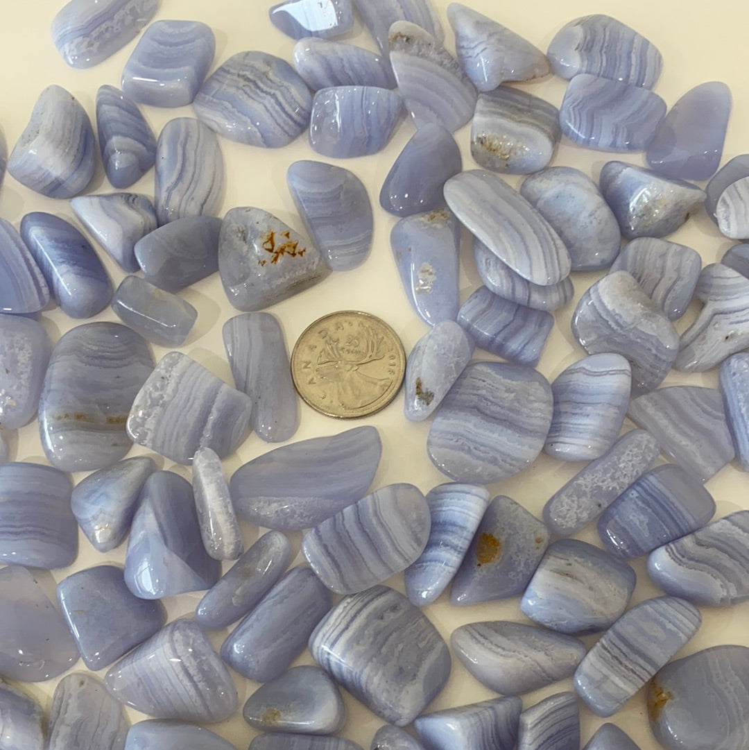 A collection of Blue Lace Agate Tumbled Healing Stones showcasing their unique blue and white lace patterns, perfect for healing and meditation.