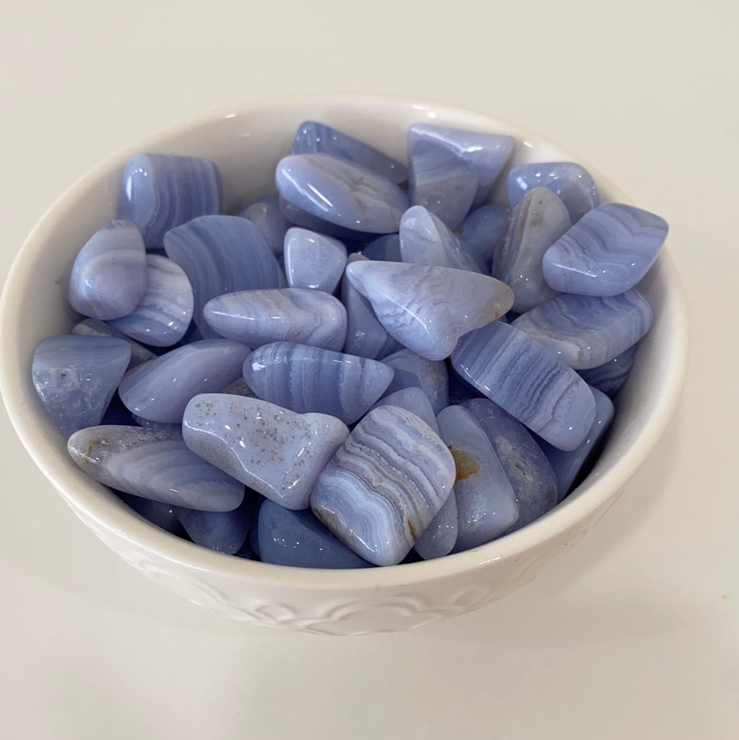 A collection of Blue Lace Agate Tumbled Healing Stones showcasing their unique blue and white lace patterns, perfect for healing and meditation.