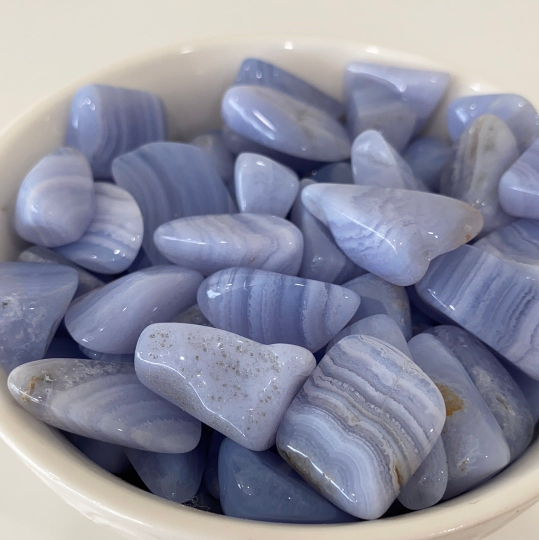 A collection of Blue Lace Agate Tumbled Healing Stones showcasing their unique blue and white lace patterns, perfect for healing and meditation.