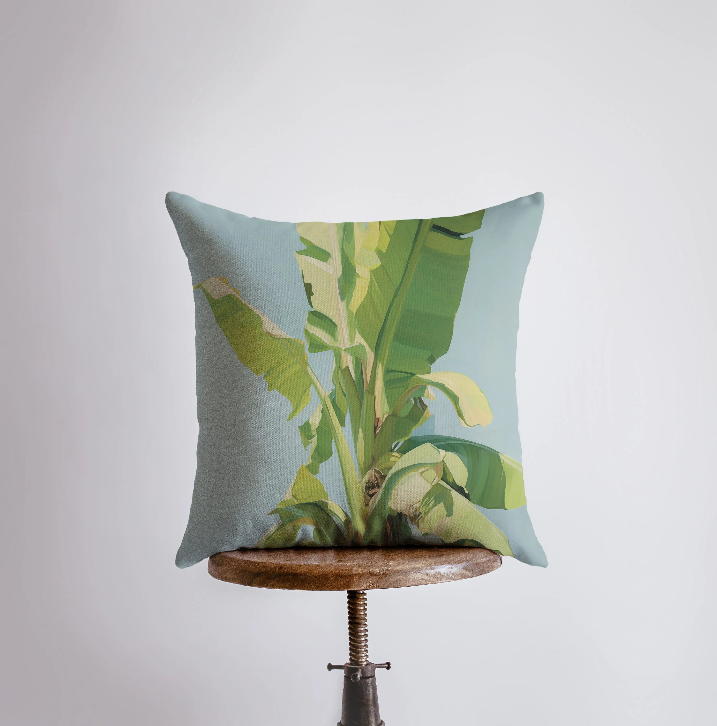 Blue Sky Palm Tree throw pillow featuring a vibrant palm tree design on a blue background, with a white back and concealed zipper.