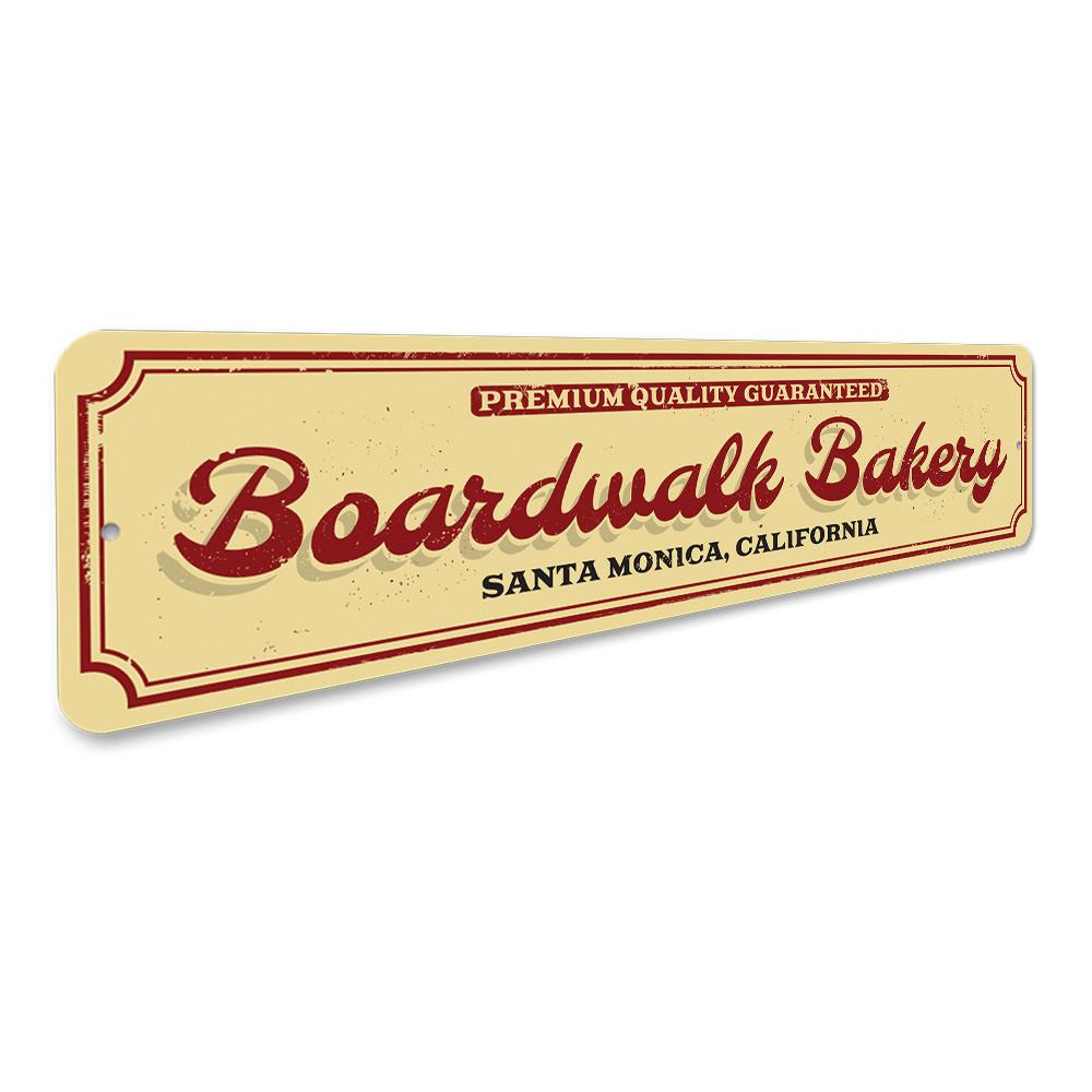 A decorative Boardwalk Bakery Sign made of high-quality aluminum, featuring customizable text for beach-themed decor.