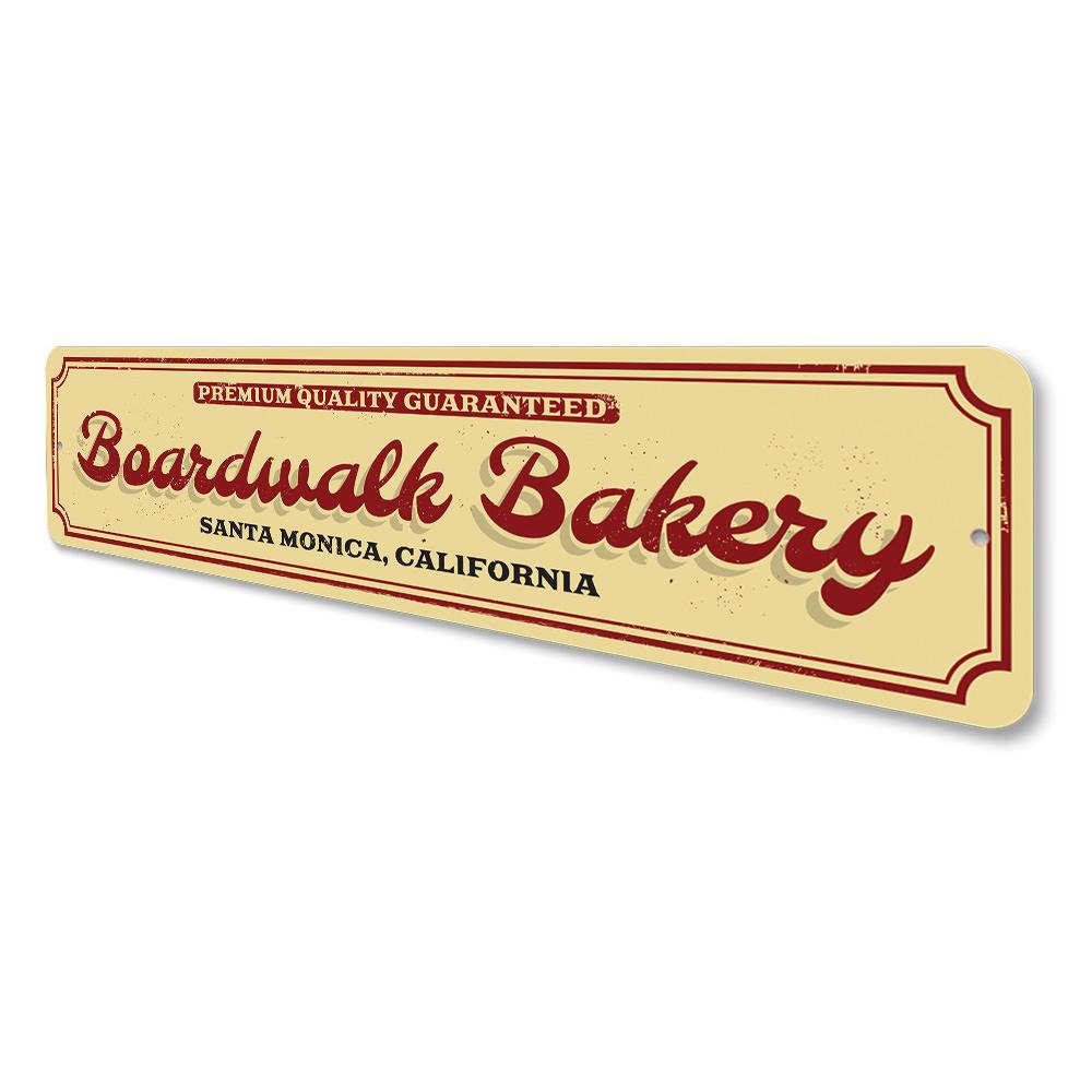 A decorative Boardwalk Bakery Sign made of high-quality aluminum, featuring customizable text for beach-themed decor.