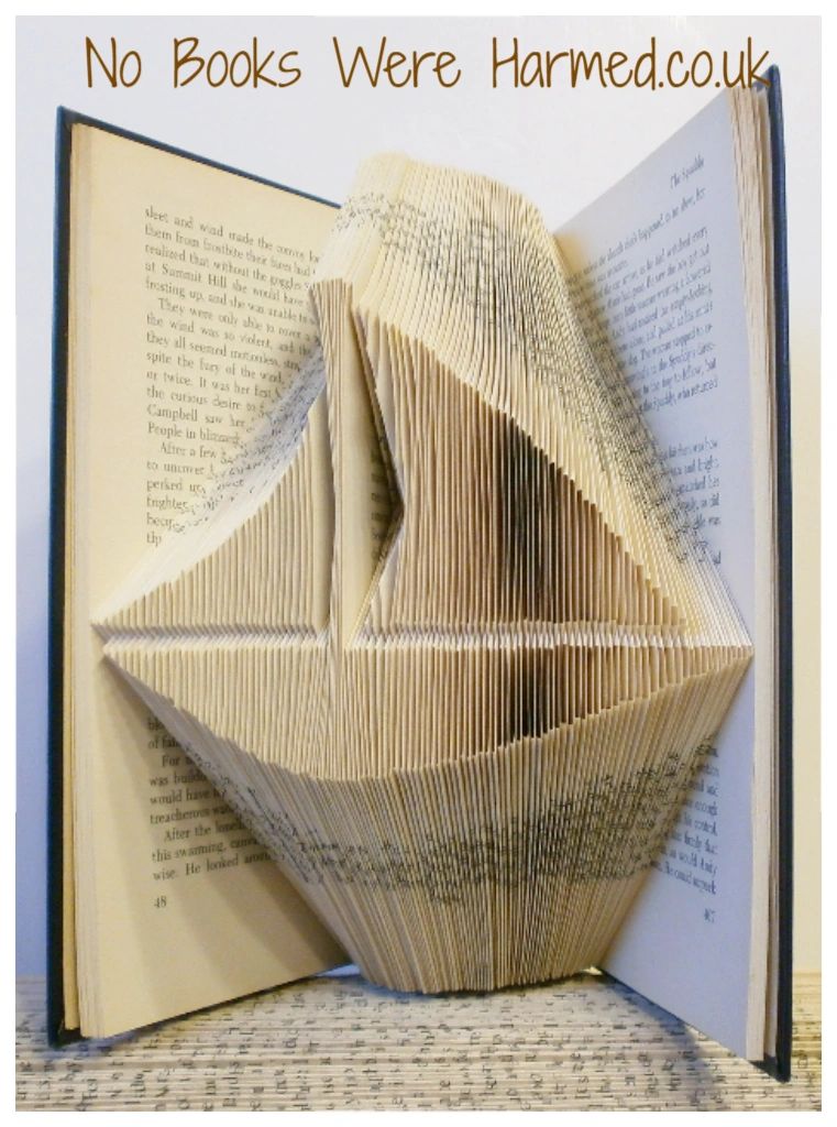 Handcrafted nautical book art made from vintage books, featuring unique designs and colors.