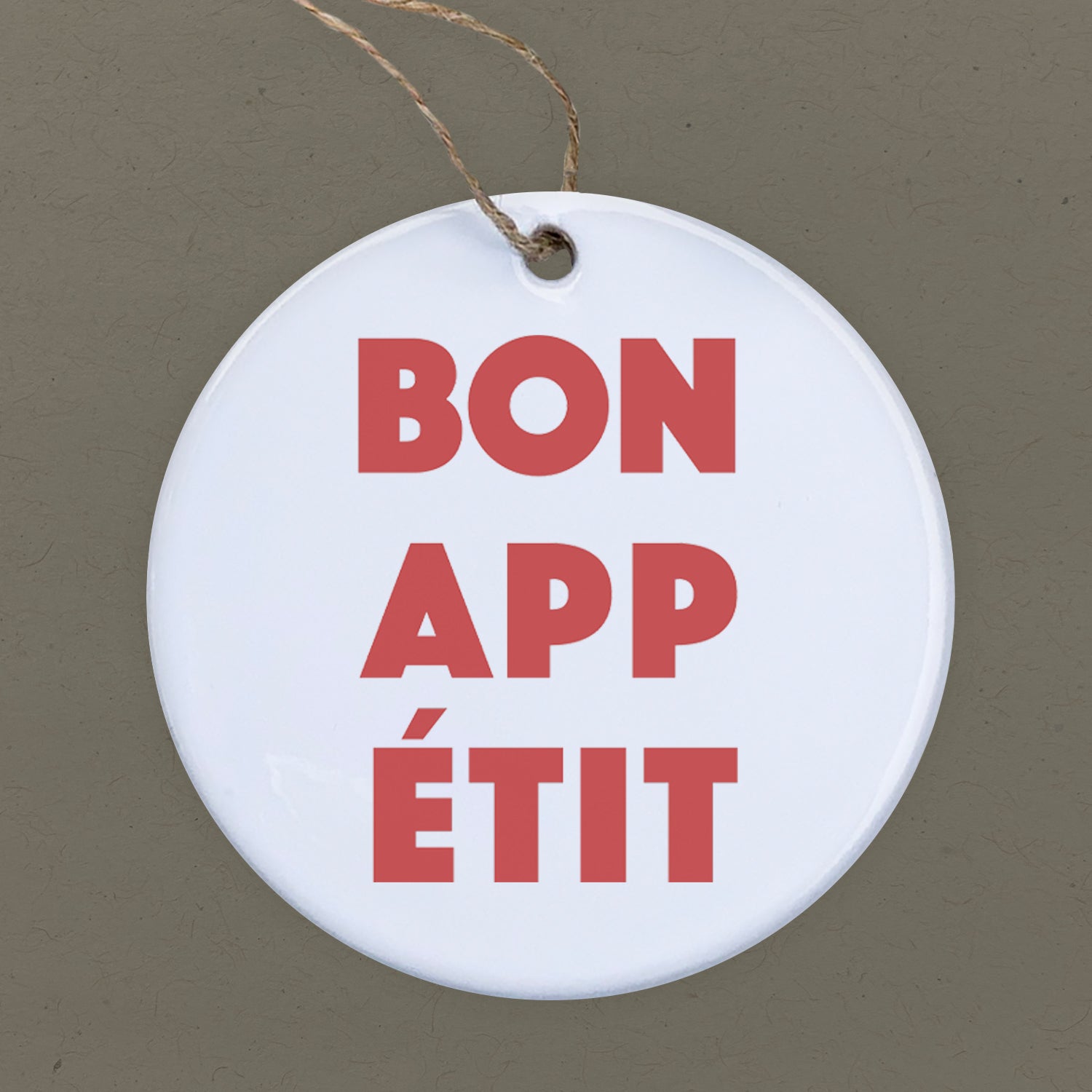 Bon Appetit porcelain ornament featuring original culinary designs, 2.75 inches in diameter.