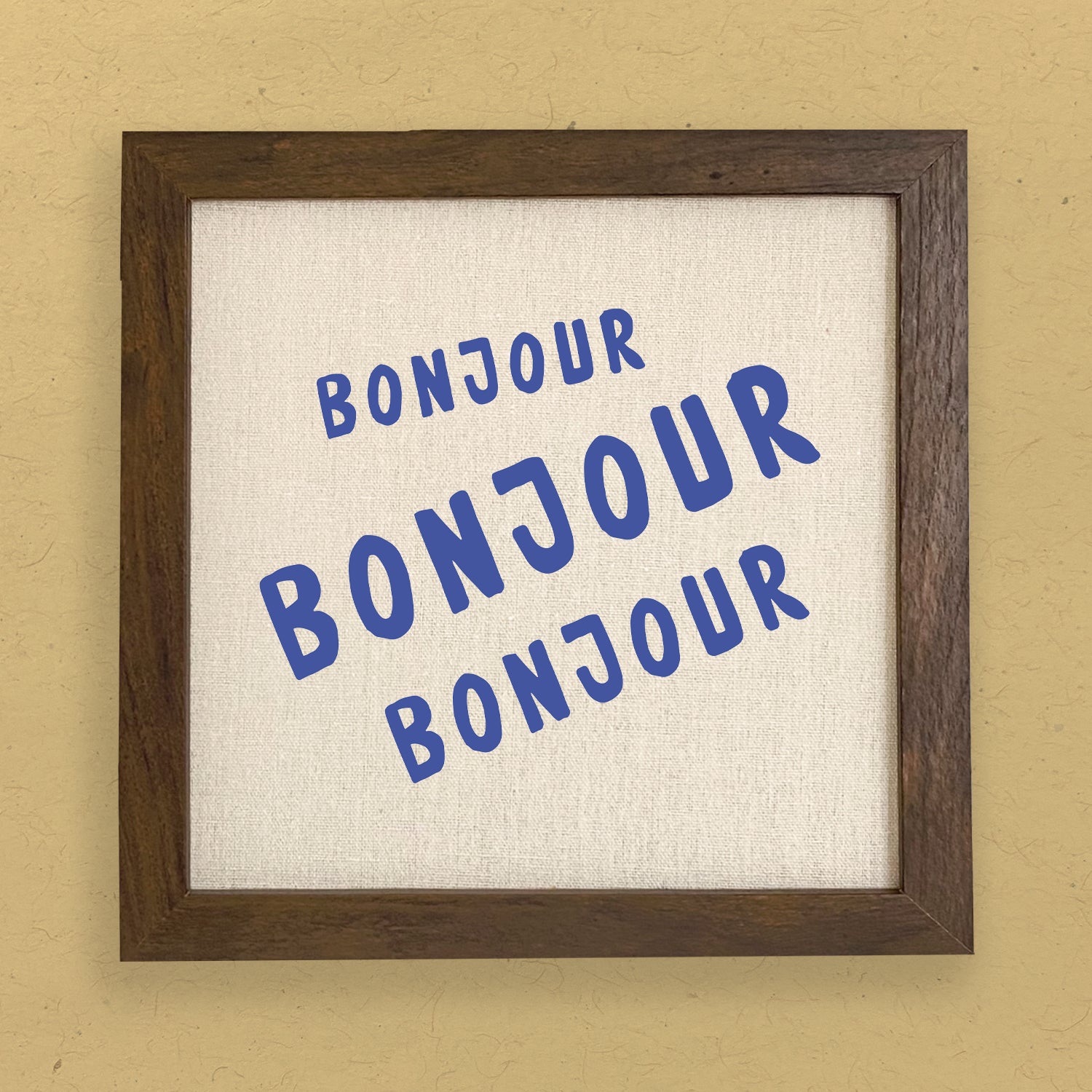 Bonjour Trois Framed Sign with a stylized wood frame, featuring eco-friendly printing on a linen-look background.