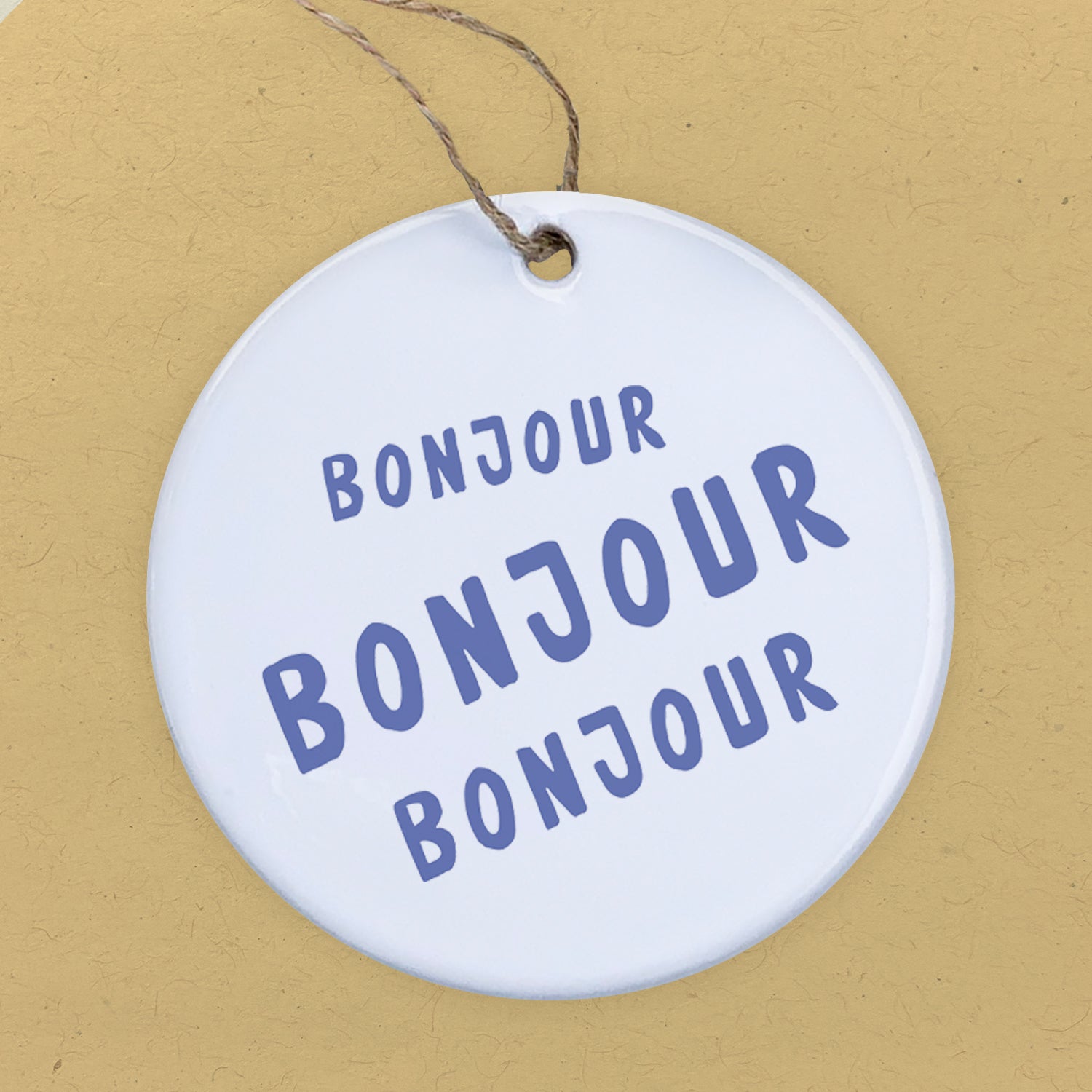 Bonjour Trois Ornament made of high-quality porcelain with a vibrant design, perfect for gifting or home decor.