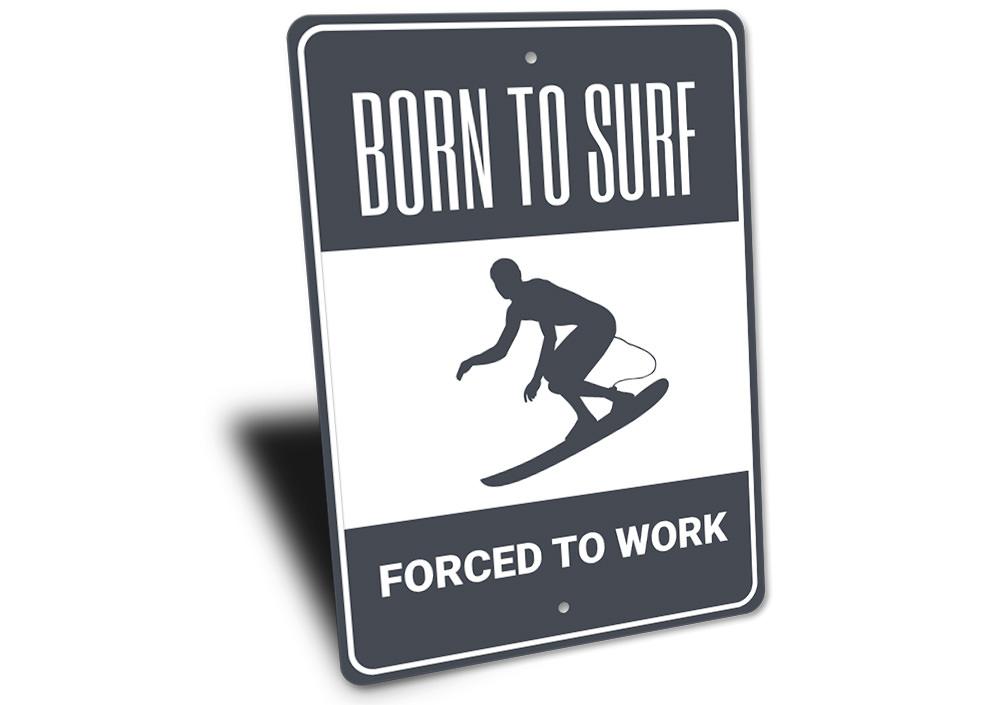 A decorative metal sign reading 'Born to Surf Forced to Work', featuring vibrant colors and a beach-themed design, perfect for coastal decor.