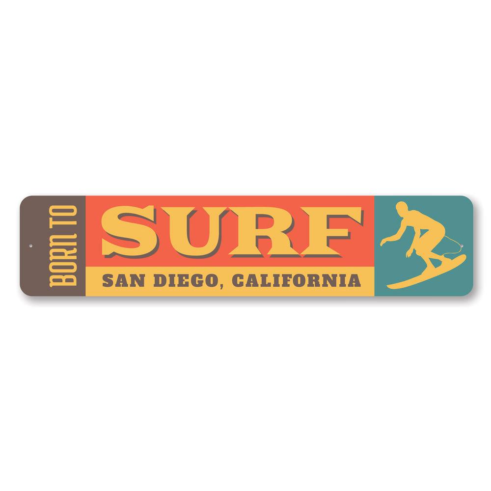 A decorative 'Born to Surf' sign made of durable aluminum, featuring vibrant colors and a beach-themed design, perfect for surf enthusiasts.