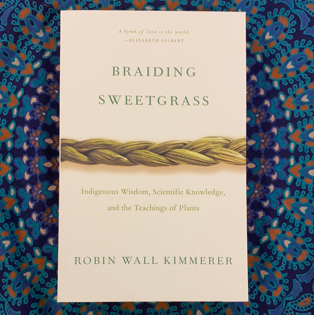 Cover of 'Braiding Sweetgrass' featuring lush greenery and natural elements, symbolizing the connection between nature and indigenous wisdom.