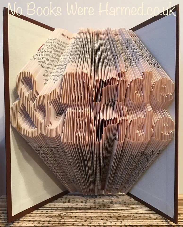 Handcrafted Bride & Bride art made from vintage books, showcasing unique folded pages in various colors.