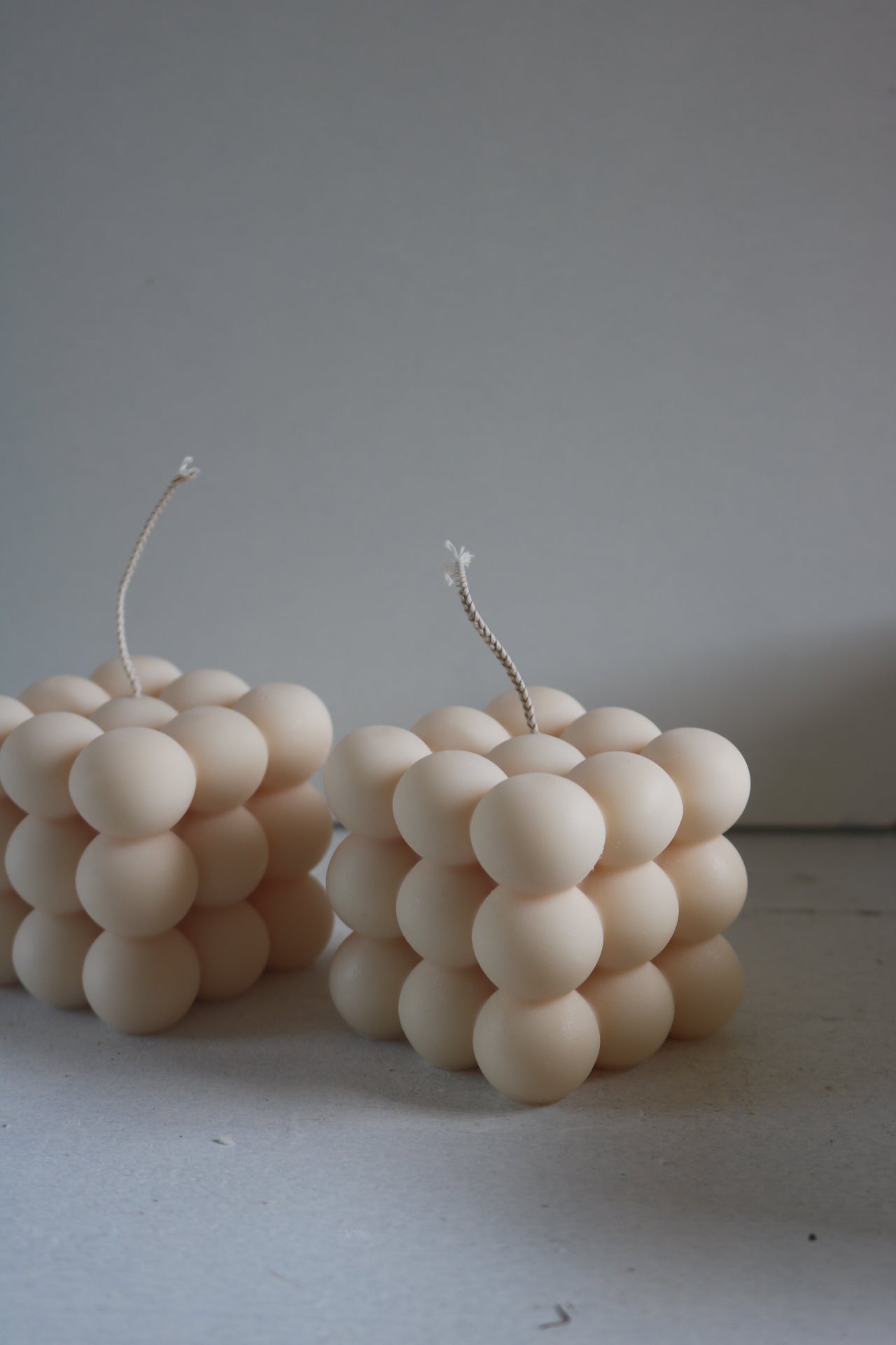 A beautifully sculptural Bubble candle made from a soy wax blend, showcasing its elegant design and soft curves.