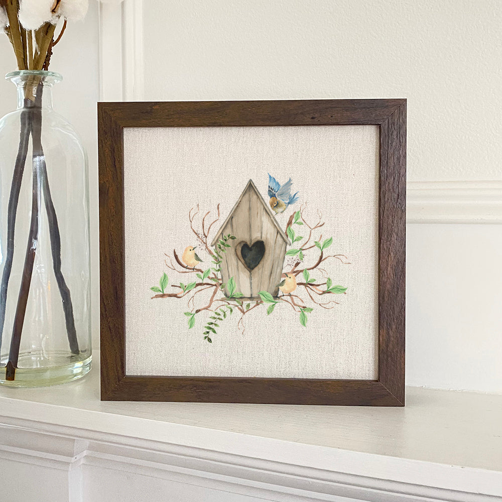 Budding Birdhouse framed sign with a stylized wood frame, eco-friendly printing on a linen-look background.