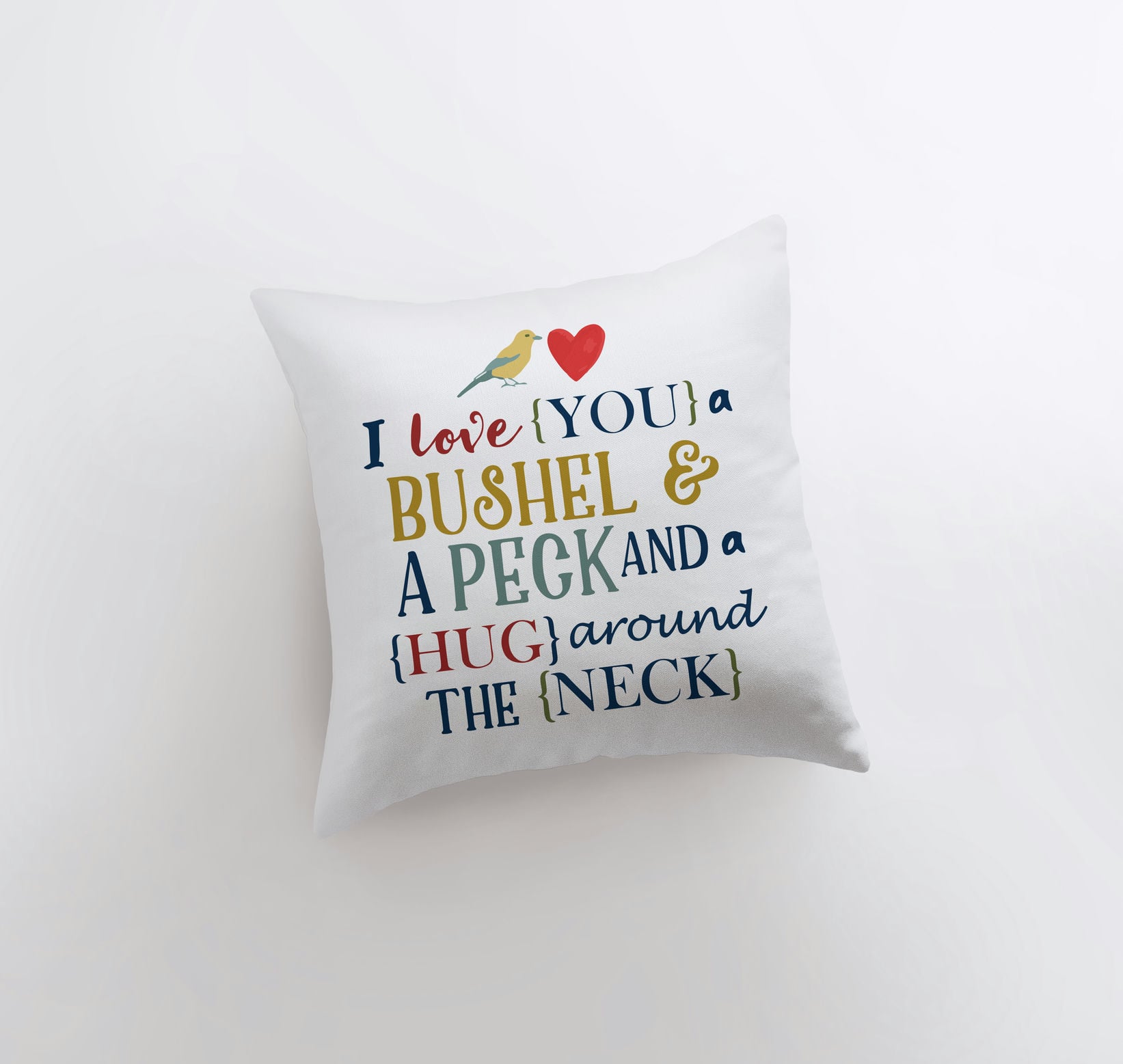 Bushel and a Peck pillow cover featuring colorful lettering on a white background, showcasing a heartfelt design.