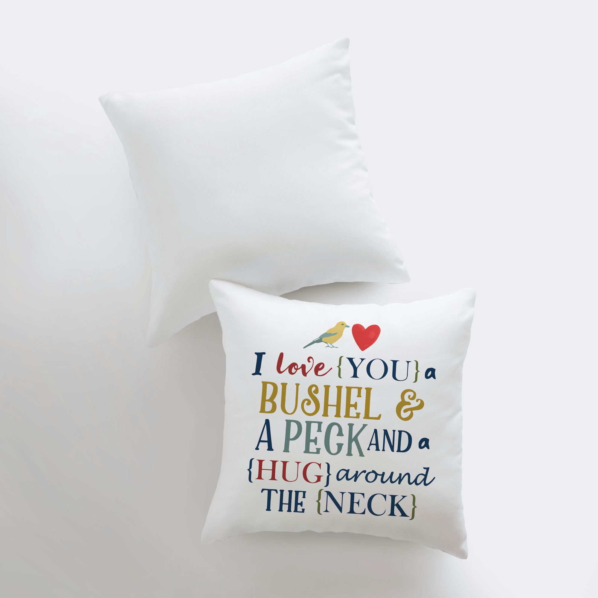 Bushel and a Peck pillow cover featuring colorful lettering on a white background, showcasing a heartfelt design.