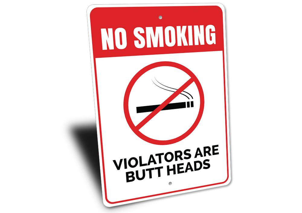 Butt Heads Smoking Sign featuring humorous text on a decorative aluminum background, ideal for man caves and home decor.