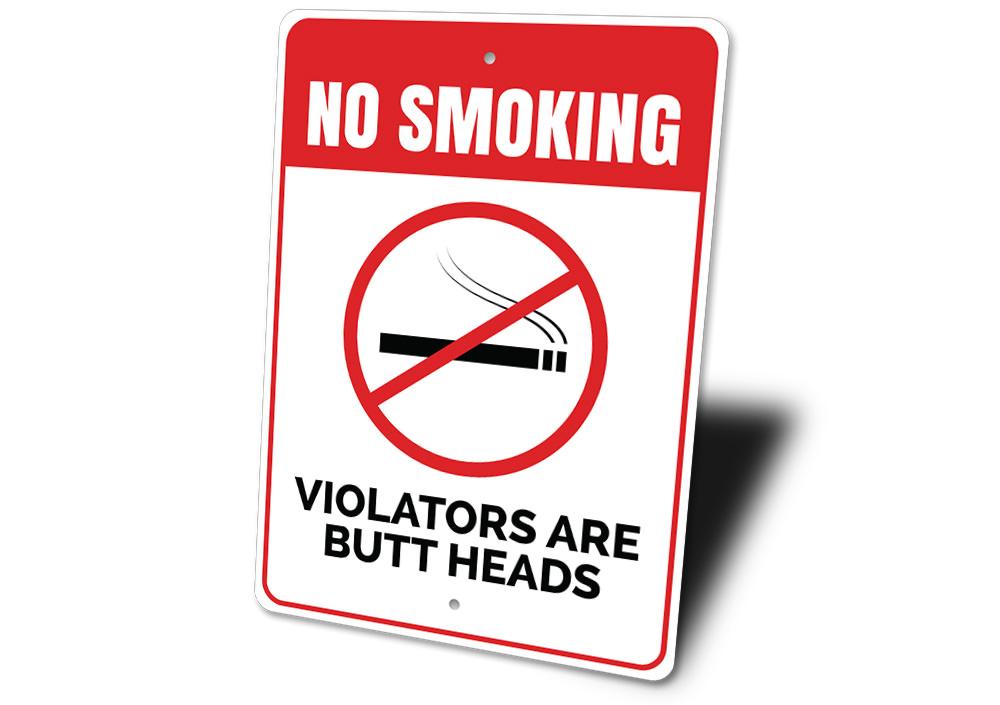 Butt Heads Smoking Sign featuring humorous text on a decorative aluminum background, ideal for man caves and home decor.