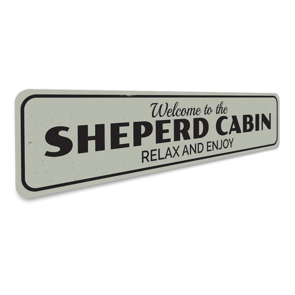 A decorative Cabin Relax & Enjoy Sign made of high-quality aluminum, featuring a rustic design perfect for lakeside homes.