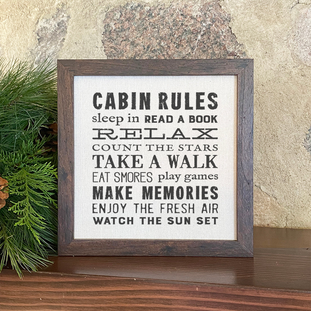 A beautifully framed Cabin Rules sign with a natural linen-style background and eco-friendly printing, perfect for cabin decor.