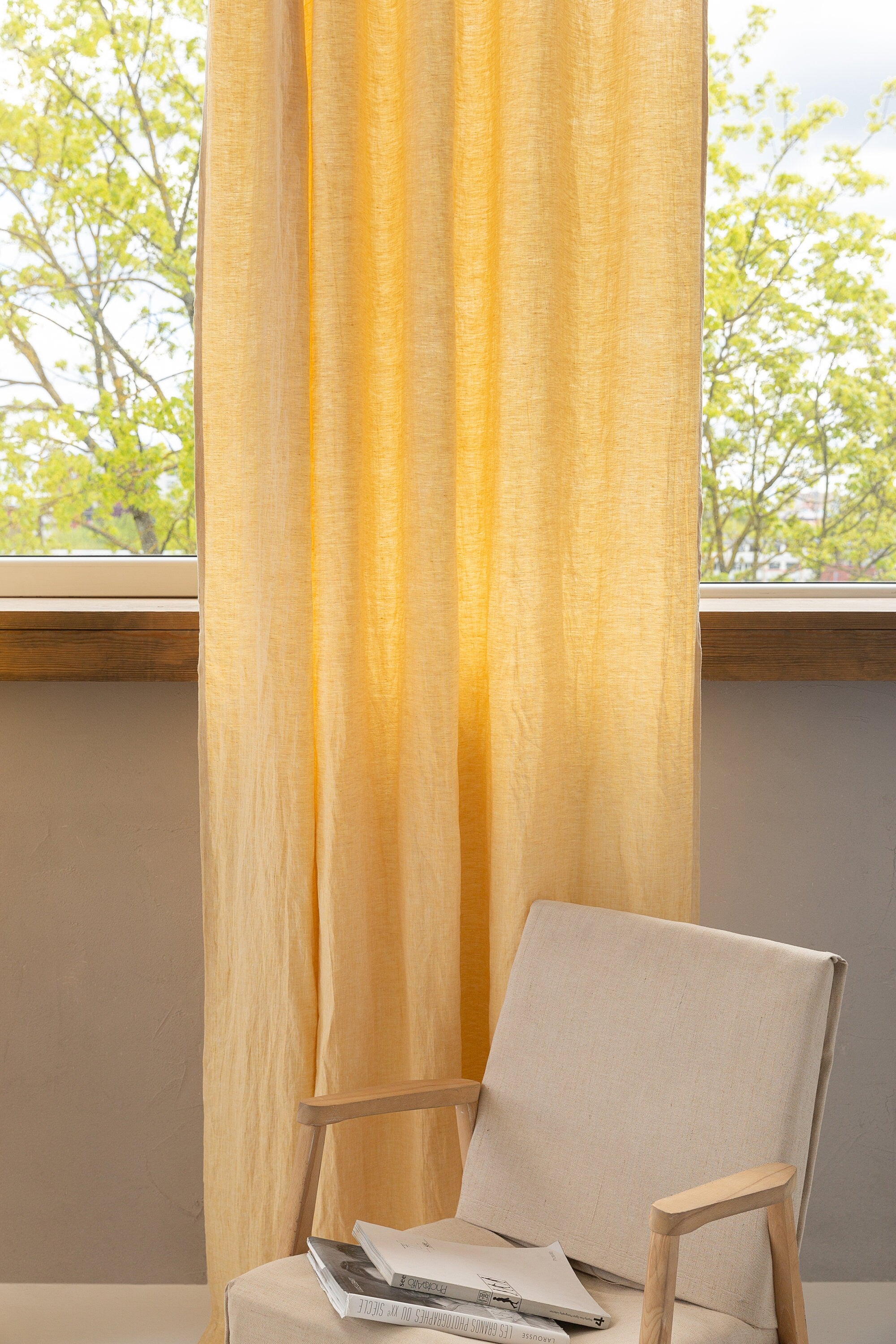 Canary Yellow linen curtain with pleating tape hanging elegantly, showcasing its semi-sheer texture and modern design.