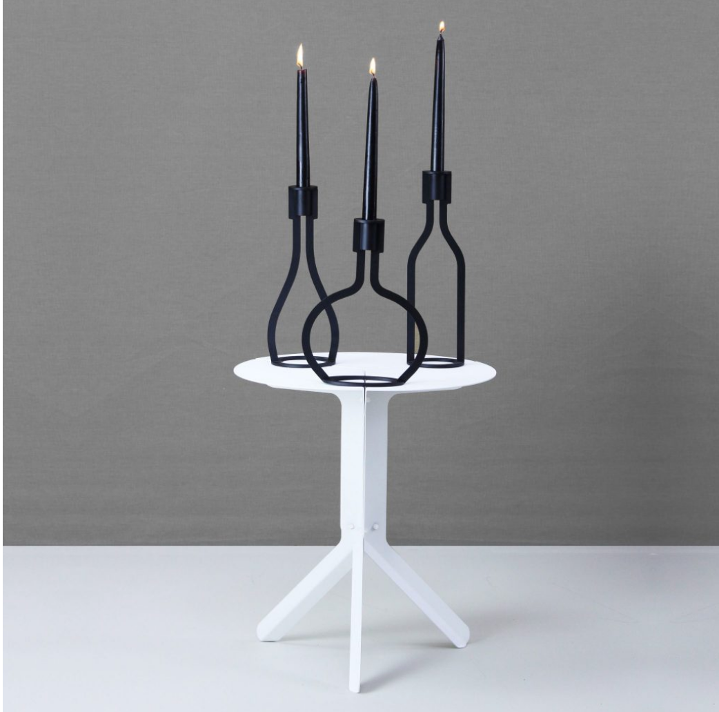 THE BOTTLE candlestick designed by Peter van de Water, featuring a sleek industrial steel design with a black matte finish.