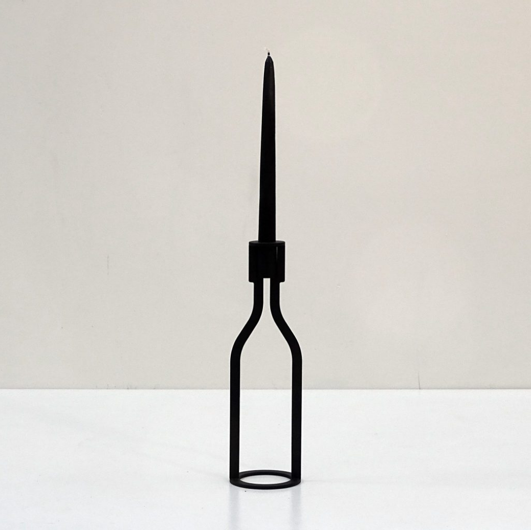 THE BOTTLE candlestick designed by Peter van de Water, featuring a sleek industrial steel design with a black matte finish.