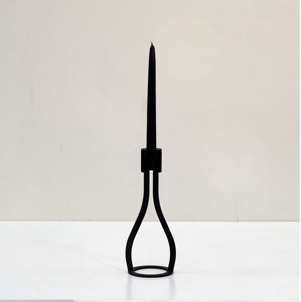 THE BOTTLE candlestick designed by Peter van de Water, featuring a sleek industrial steel design with a black matte finish.